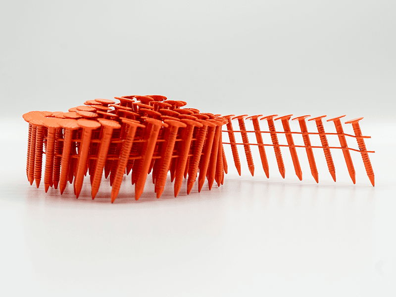 A coil of fluorescent orange LumaNail roofing nails, partly unwound to show the ring shanks and waffle heads.
